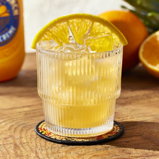 The Sunburn cocktail garnished with an orange wedge